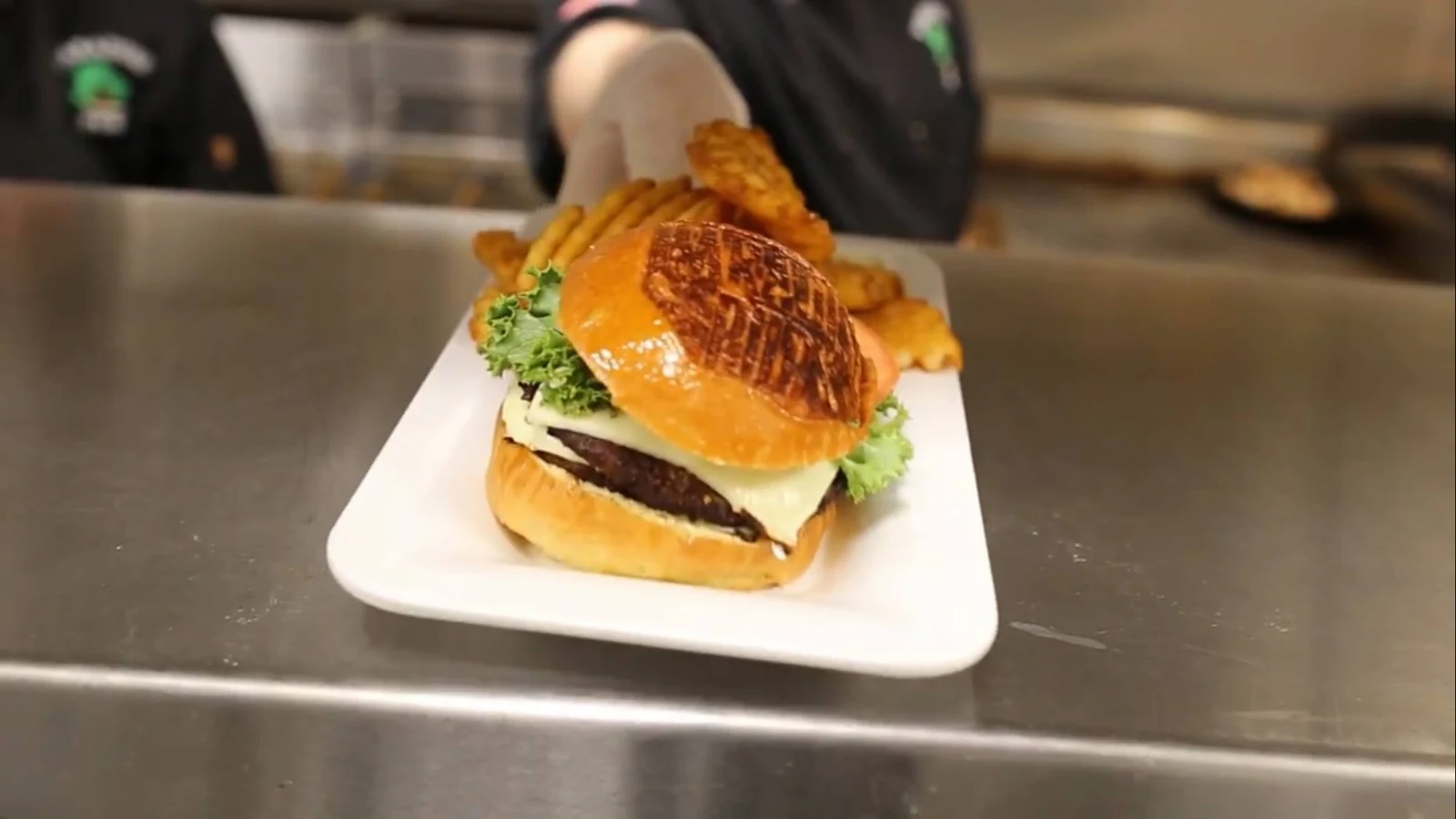 A burger prepared in the kitchen at Paradise Pub